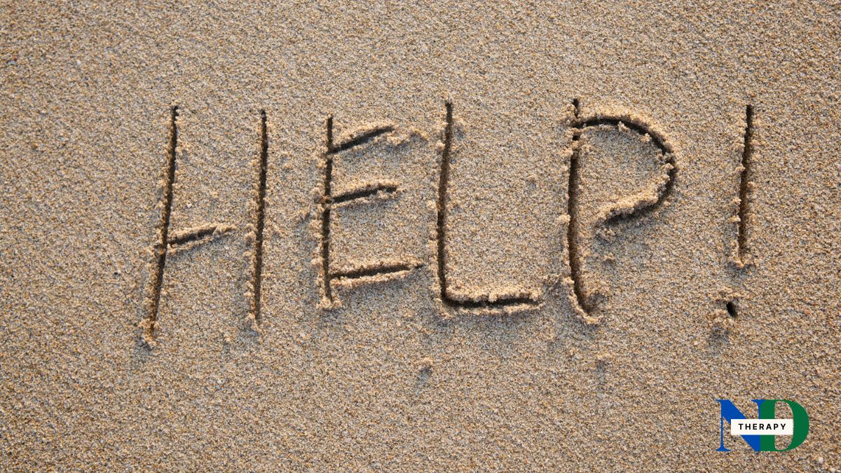 Help written in sand.
