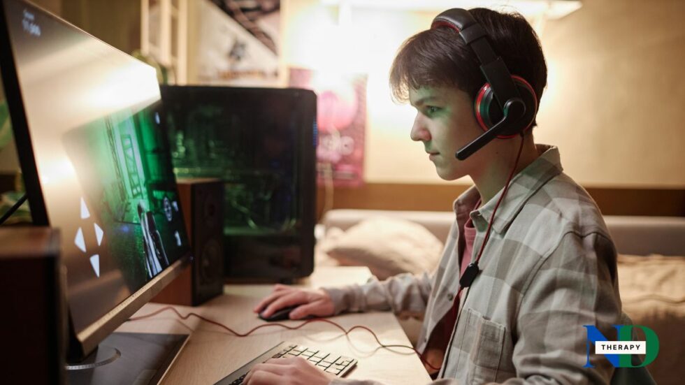 Teen boy on a gaming computer.