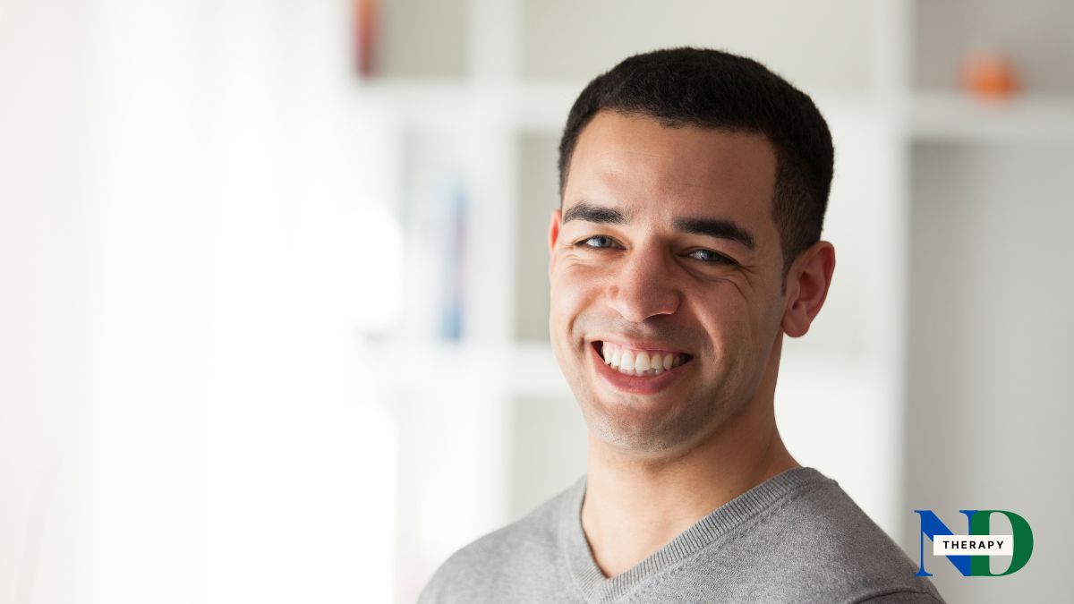 man-smiling-gray-shirt Smiling man wearing a gray shirt.