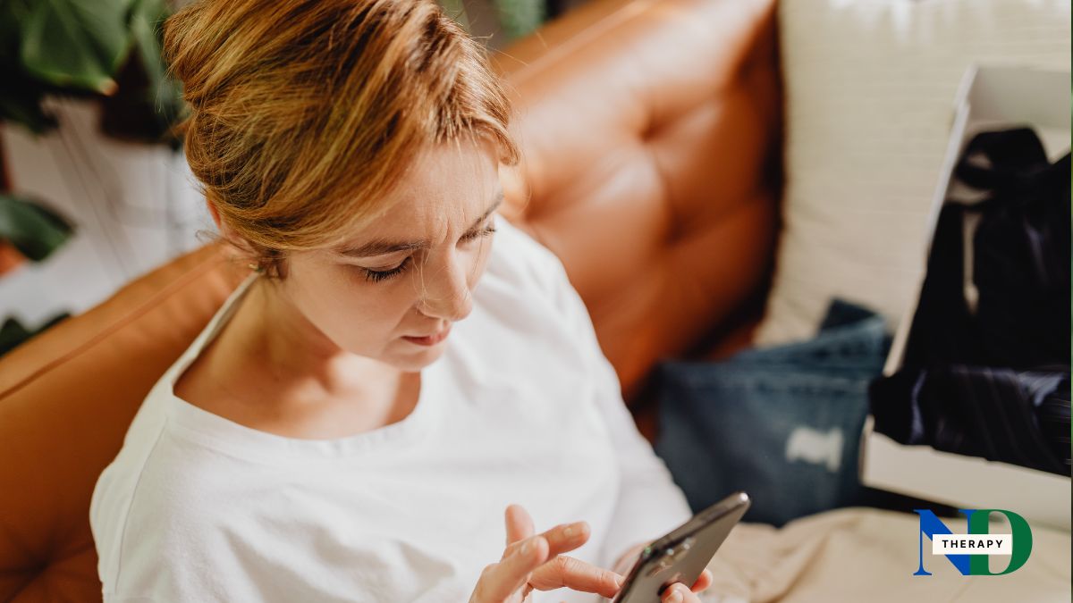 Adult woman using phone in bed.