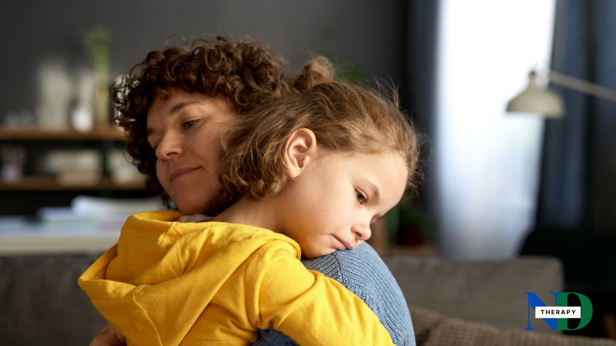 A sad child comforted by her mother. 