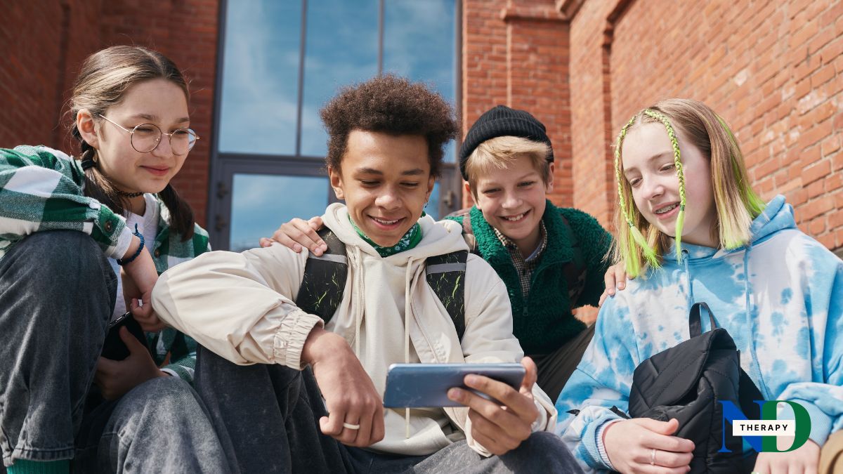 Children looking at a phone at school.