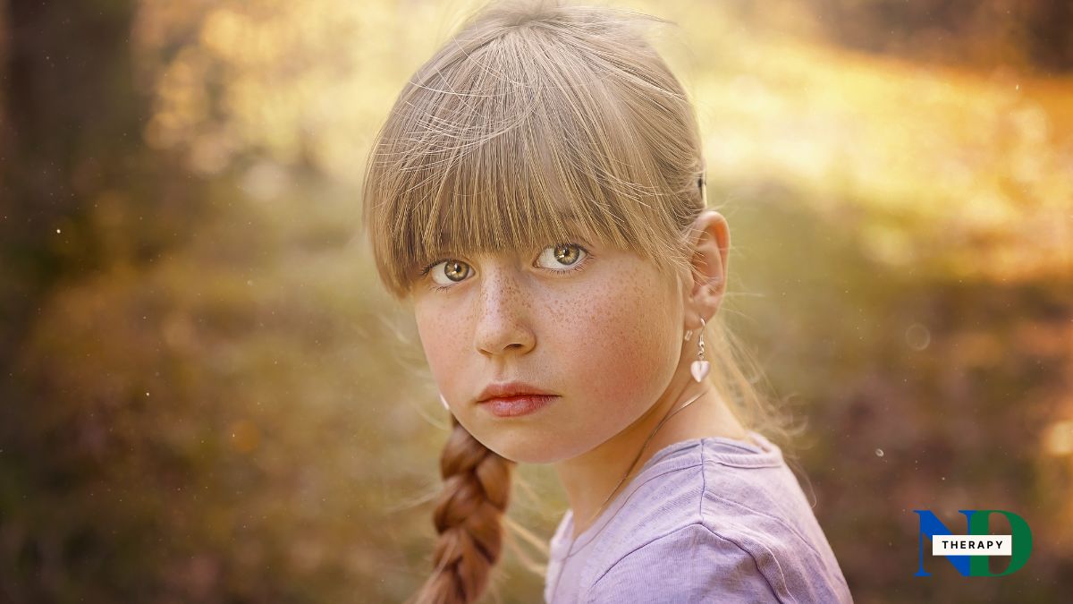 A girl with pigtails in a bright background.