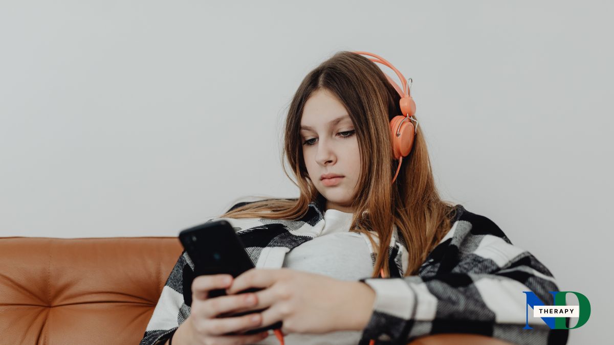 Teen girl wearing headphones on her smartphone.